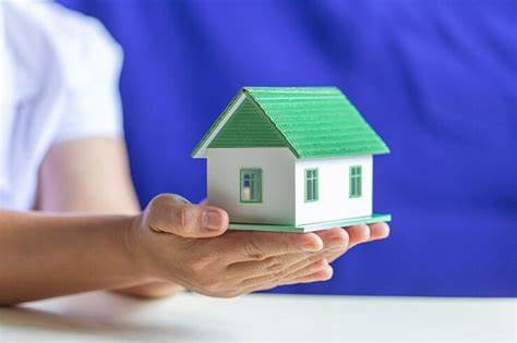 Image of hands holding a house