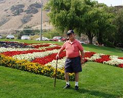 Photo of Tony DeRooy in front of American flag garden bed at Rocky Reach 